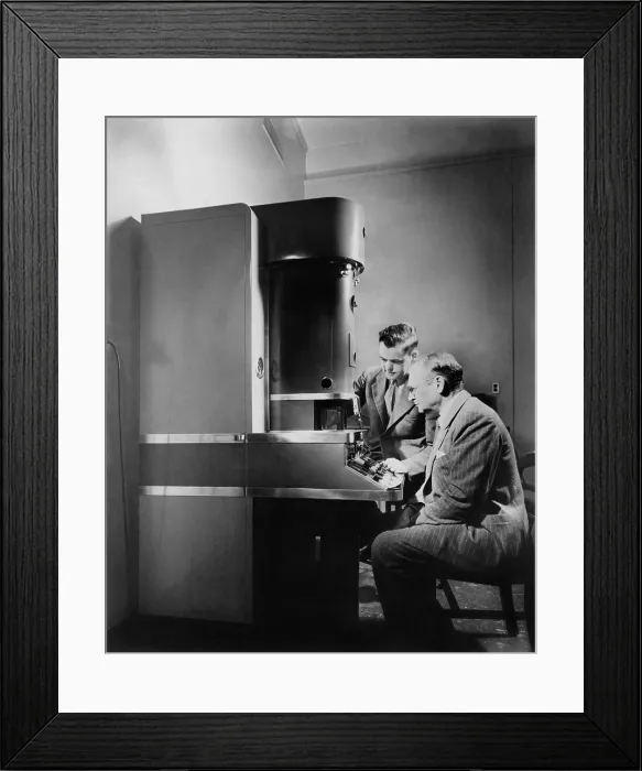 Framed Print : Dr. V.K. Zworykin and Dr. James Hillier of RCA Laboratories at the electron microscope. Invented in the 1930, it exceeded magnification of optical microscopes. Ca. 1945