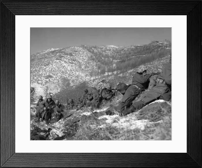 Framed Print : U.S. Marine infantrymen engage Chinese forces at the Chosin Reservoir. They take cover behind large boulders. Dec. 5, 1950. Korean War, 1950-53. (BSLOC_2014_11_89)