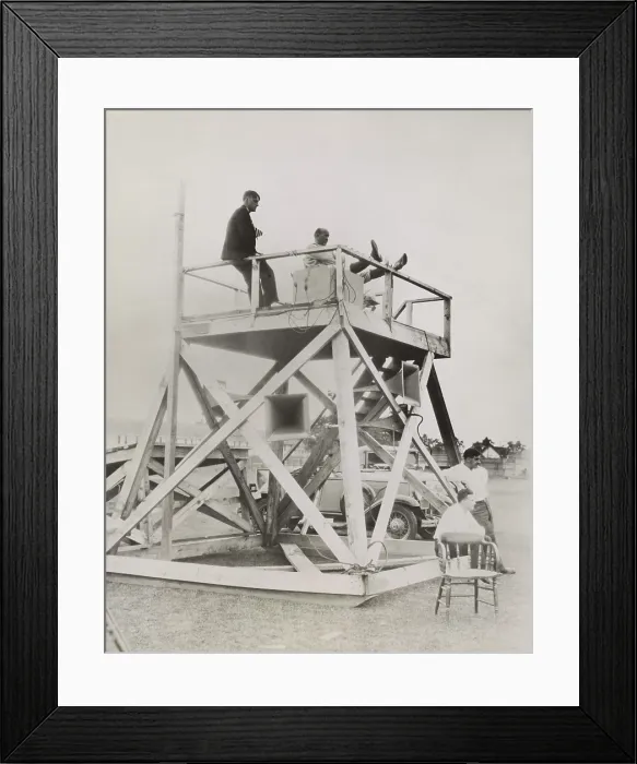Framed Print : Knute Rockne, seated on coaching tower, as he overlooks the football field at South Bend. Rockne directs the action through the advanced technology of loud speakers