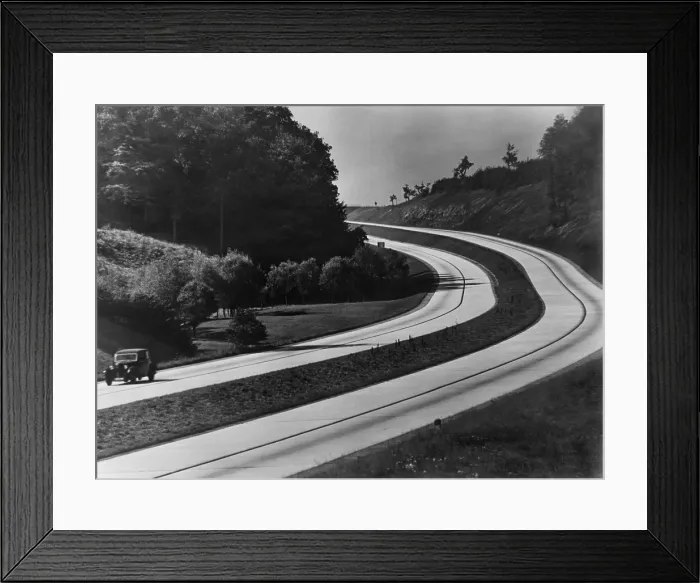 Framed Print : An automobile on the sweeping curves of the Autobahn with view of the countryside