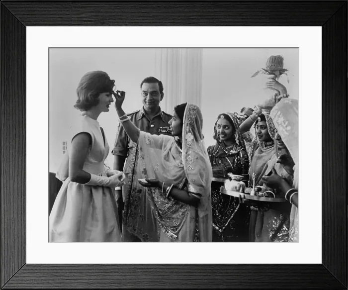 Framed Print : Jacqueline Kennedy having a bindi placed on her forehead at Jaipur, India. A bindi is a red dot on the forehead which is a sign of marriage. - (BSLOC_2015_1_133) Framed Print : Jacqueline Kennedy having a bindi placed on her forehead at Jaipur, India. A bindi is a red dot on the forehead which is a sign of marriage. - (BSLOC_2015_1_133)