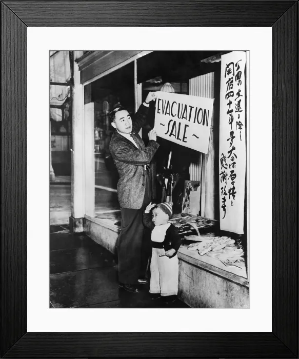 Framed Print : Japanese-American merchant posts a sale sign on his San Francisco store in preparation for internment