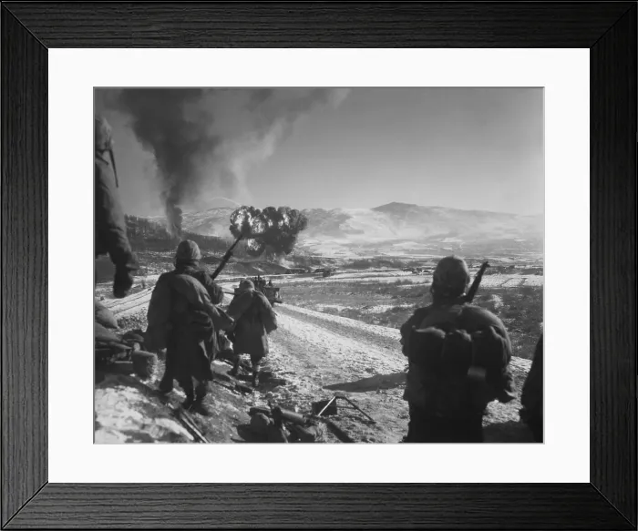 Framed Print : U.S. Marines pause at the roadblock on the way from Hagaru to Kotori in the withdrawal from the Chosin Reservoir. Marine Corsairs napalm an abandoned U.S Framed Print : U.S. Marines pause at the roadblock on the way from Hagaru to Kotori in the withdrawal from the Chosin Reservoir. Marine Corsairs napalm an abandoned U.S