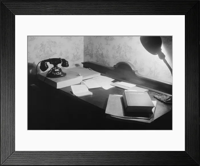 Framed Print : A US government clerk's home office desk with books, telephone and directory, and a desk lamp. Washington, D.C. 1939 Framed Print : A US government clerk's home office desk with books, telephone and directory, and a desk lamp. Washington, D.C. 1939