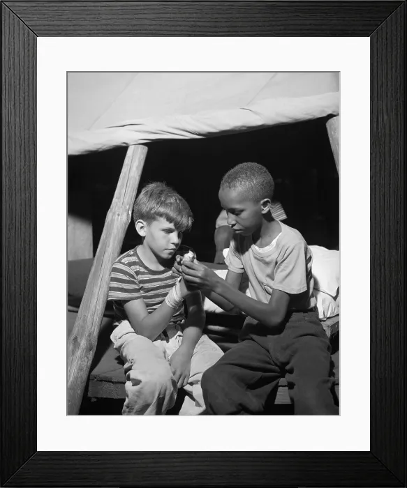 Framed Print : African American camper helps a White bubby with his bandaged hand. They are at Camp Nathan Hale, Southfields, NY, which was supported by the Methodist Camp Service in Aug Framed Print : African American camper helps a White bubby with his bandaged hand. They are at Camp Nathan Hale, Southfields, NY, which was supported by the Methodist Camp Service in Aug