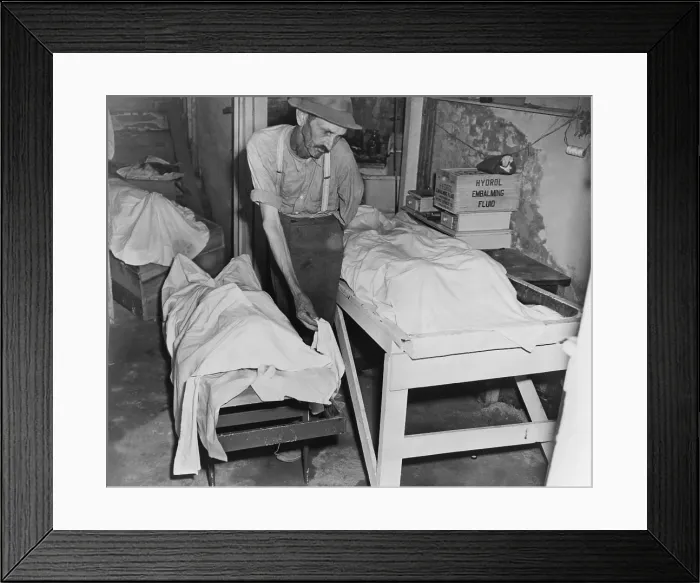 Framed Print : Sheet covered bodies of four lynched African Americans in a Georgia morgue. The coroner places a sheet over the body of one of four