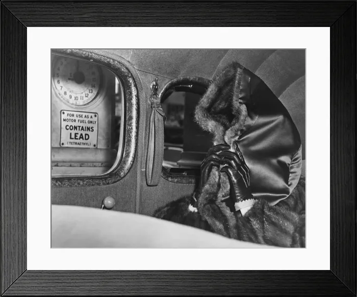 Framed Print : Mae Capone, wife of gangster Al Capone, hides her face from photographers with hood of her fur coat. She is at a Morgan Hill, California, gas station in March 1, 1938