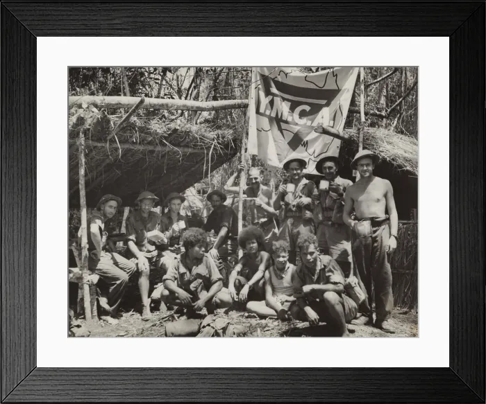 Framed Print : New Guinean natives and Allied troops pause at a YMCA in the jungle