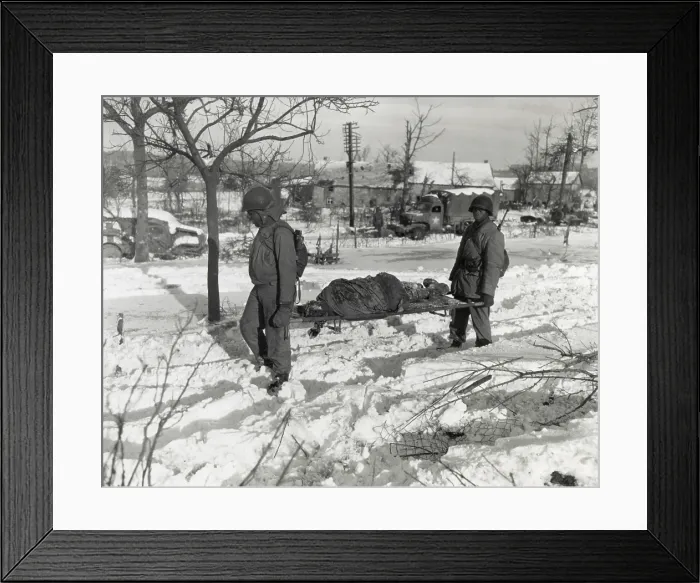 Framed Print : Two African American soldiers carry the body of an soldier on a stretcher during World War 2