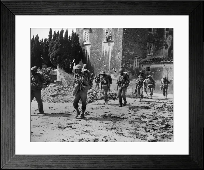 Framed Print : African American combat soldiers on patrol near bombed buildings, somewhere in Europe in 1944. In the spring of 1944, the U.S
