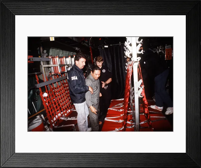 Framed Print : Panamanian leader General Manuel Noriega former CIA intelligence asset during the civil wars in Nicaragua and El Salvador being escorted onto a U.S Framed Print : Panamanian leader General Manuel Noriega former CIA intelligence asset during the civil wars in Nicaragua and El Salvador being escorted onto a U.S