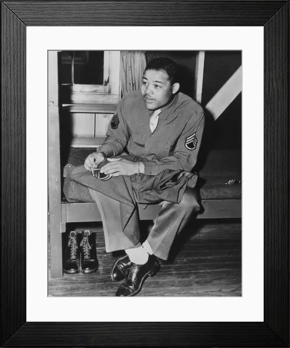 Framed Print : Heavyweight champion Joe Louis sews on the stripes of a technical sergeant