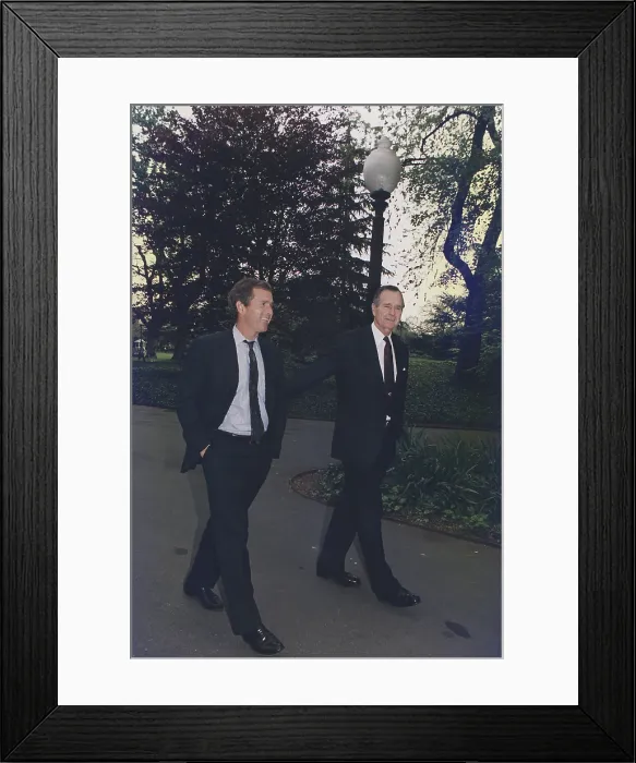 Framed Print : President George H.W. Bush walks on White House grounds with his son George W. Bush then head of an investment group that owned the Texas Rangers Baseball team. April 29 1992 Framed Print : President George H.W. Bush walks on White House grounds with his son George W. Bush then head of an investment group that owned the Texas Rangers Baseball team. April 29 1992