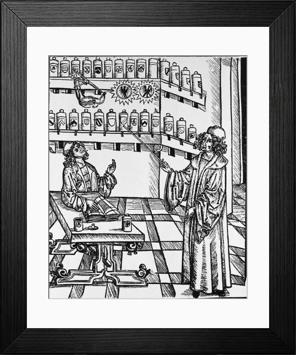 Framed Print : A pharmaceutical lesson showing the master, pointing to shelves of apothecary jars, instructing the apprentice at a table with an open book. Woodcut from MEDICINARIUS Framed Print : A pharmaceutical lesson showing the master, pointing to shelves of apothecary jars, instructing the apprentice at a table with an open book. Woodcut from MEDICINARIUS