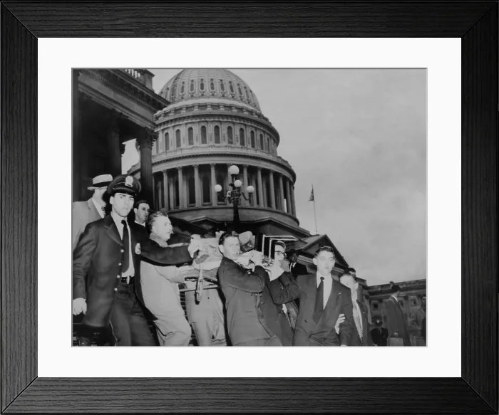Framed Print : Aftermath of the Puerto Rican terrorist shooting in the U.S. House of Representatives. Police and aids carry Rep. Kenneth Roberts from the House where he suffered leg wound