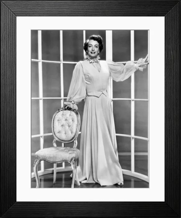 Framed Print : THIS WOMAN IS DANGEROUS, Joan Crawford, in a pink wool and nylon hostess suit by Sheila O'Brien, 1952 Framed Print : THIS WOMAN IS DANGEROUS, Joan Crawford, in a pink wool and nylon hostess suit by Sheila O'Brien, 1952