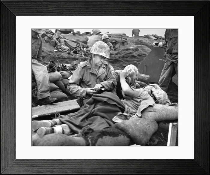 Framed Print : Navy doctor and corpsman treat a wounded Marine on Iwo Jima. Feb. 19-March 26, 1945, during World War 2. (BSLOC_2013_14_256) Framed Print : Navy doctor and corpsman treat a wounded Marine on Iwo Jima. Feb. 19-March 26, 1945, during World War 2. (BSLOC_2013_14_256)