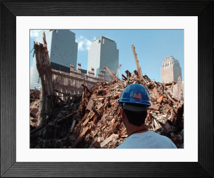 Framed Print : Worker at the pile of rubble from the collapse of WTC 2, the South Tower on Oct. 3, 2001. The ruins of the Twin Towers formed 15 meters high piles