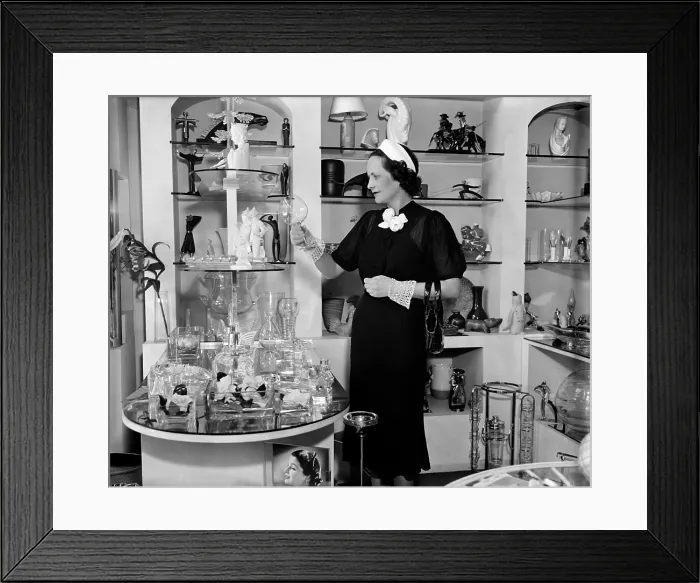 Framed Print : Mrs. Claude Pepper wife of the Democratic Senator from Florida admiring a glass in a shop on Connecticut Avenue. July 27 1937. (BSLOC_2010_18_112)