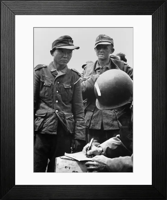 Framed Print : Japanese youth, wearing a Nazi uniform, was among German prisoners captured on the beaches of France. American Army captain is taking his name and number Framed Print : Japanese youth, wearing a Nazi uniform, was among German prisoners captured on the beaches of France. American Army captain is taking his name and number