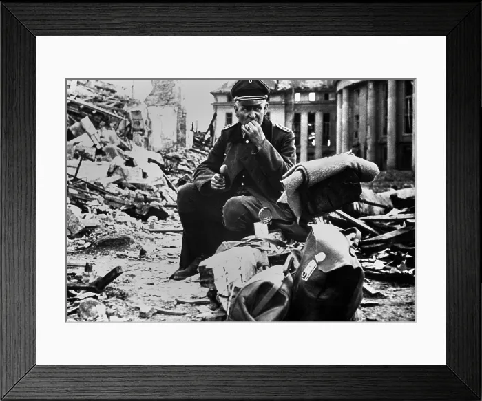 Framed Print : German Officer POW eating a can of U.S. C-rations, in the ruins of Saarbrucken. March 1945, during World War 2. (BSLOC_2013_14_295)