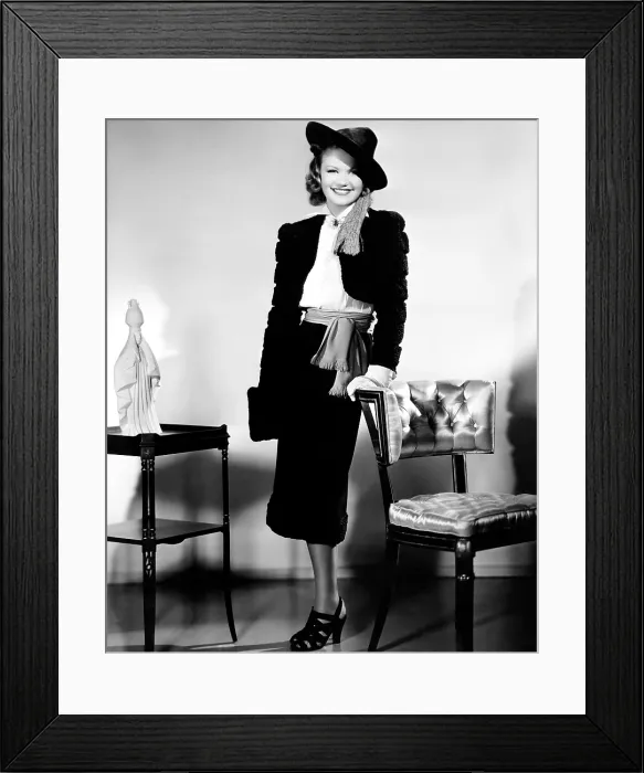 Framed Print : LOVE AND HISSES, Simone Simon, in a black broadcloth suit trimmed in Persian lamb, with a white crepe blouse and scarlet belt, 1937