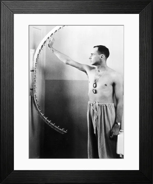 Framed Print : Physical therapy patient using finger walker to increase flexibility and range of motion in shoulder. Ca. 1950