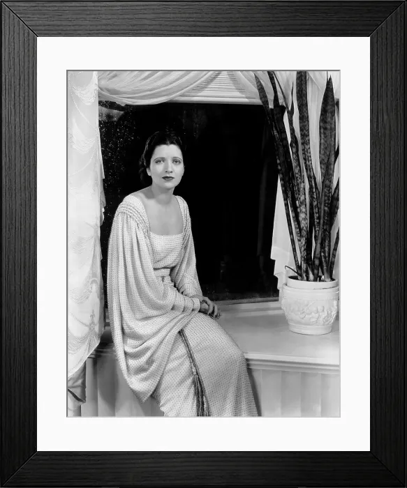 Framed Print : LIVING ON VELVET, Kay Francis, in a white wool-crepe dress dotted with rhinestones, designed by Orry-Kelly, 1935