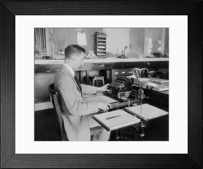 Framed Print : Man operating a Post Office money order machine. Ca. 1930. (BSLOC_2010_18_49)