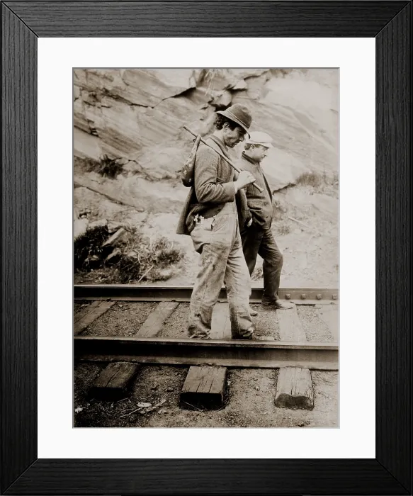 Framed Print : Two tramps, one with a handkerchief-bound bundle on a stick, walking on train tracks, seeking an opportunity to hop on a freight train. Ca. 1910 Framed Print : Two tramps, one with a handkerchief-bound bundle on a stick, walking on train tracks, seeking an opportunity to hop on a freight train. Ca. 1910