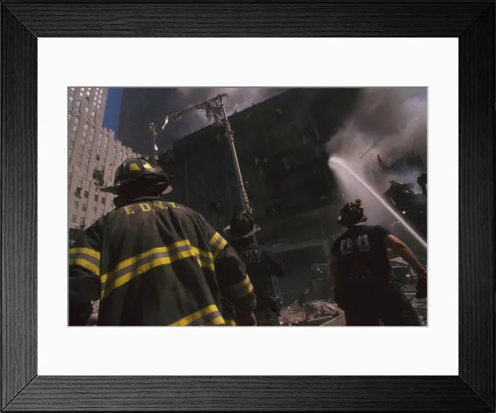 Framed Print : Fire fighter at World Trade Center site following September 11th terrorist attack. The stream water is to the still standing WTC 6