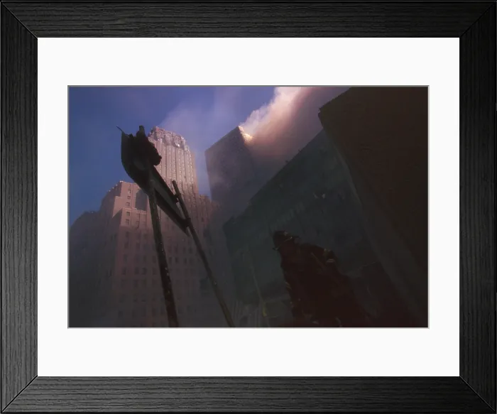 Framed Print : Fire fighter at base of burning WTC 6 following the North Tower (WTC 1) collapse. Dense dust and smoke block sunlight