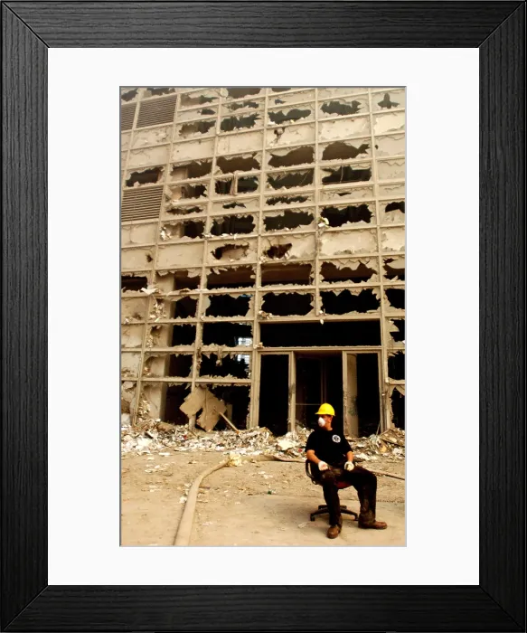 Framed Print : NYC rescue worker takes a break on an office chair from a damaged building on Barclay Street. Sept. 13, 2001. New York City, 2 days after September 11, 2001 terrorist attack. U.S
