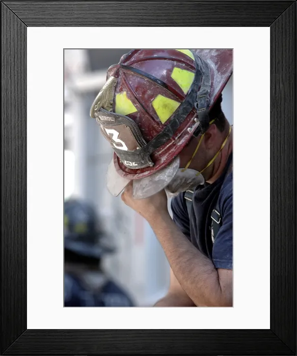 Framed Print : NYC Fireman takes a break during the rescue operations on Sept. 14, 2001