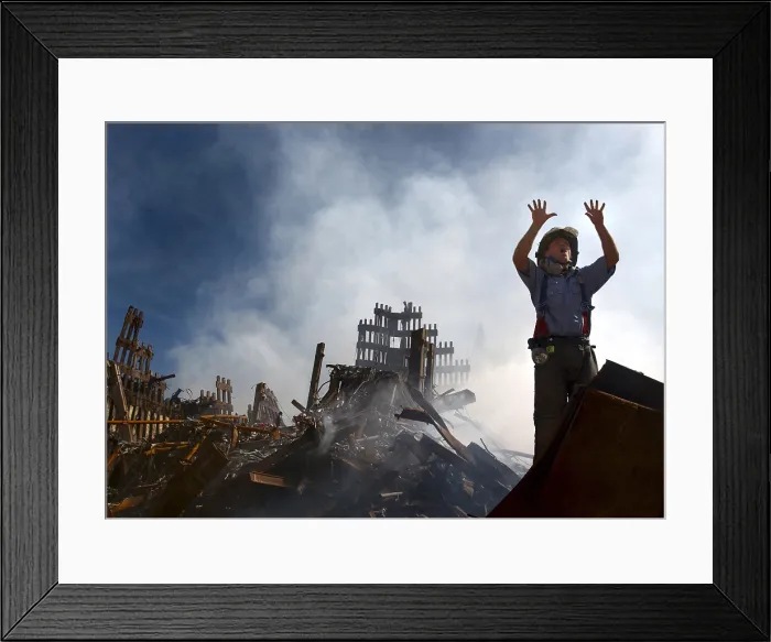 Framed Print : NYC Fireman signals for 10 more rescue workers to come into the rubble of the Ground Zero. Sept. 15, 2001