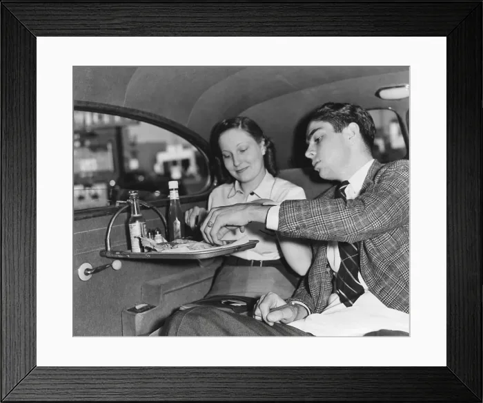 Framed Print : Drive-in restaurant in Hollywood, Los Angeles. June 29, 1938. California couple enjoying lunch in the back seat of their car