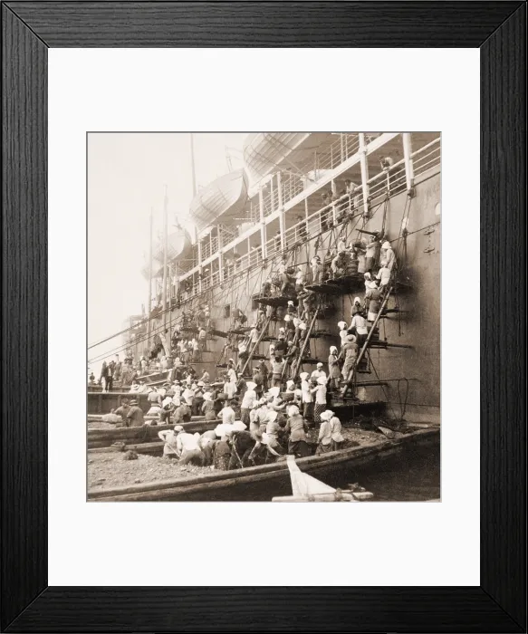Framed Print : Coaling station in Nagasaki, Japan. Young men and women on barges and scaffolding form a bucket brigade, passing coal up the side of the mail ship during refueling