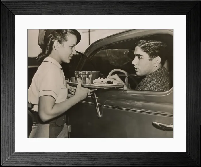 Framed Print : Drive-in restaurant in Hollywood, Los Angeles. June 29, 1938. Waitress brings food to drivers who do not have time to stop at a restaurant. - (BSLOC_2014_17_114) Framed Print : Drive-in restaurant in Hollywood, Los Angeles. June 29, 1938. Waitress brings food to drivers who do not have time to stop at a restaurant. - (BSLOC_2014_17_114)