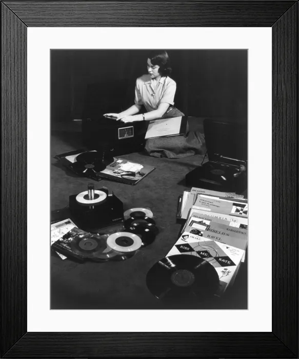 Framed Print : Record players matching the three types of records available in 1949. Young woman seated on floor with record players and 78 r.p.m.(revolutions per minute), 45 r.p.m Framed Print : Record players matching the three types of records available in 1949. Young woman seated on floor with record players and 78 r.p.m.(revolutions per minute), 45 r.p.m