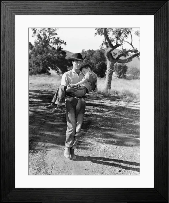 Framed Print : THE RED PONY, Robert Mitchum, carrying Peter Miles, 1949