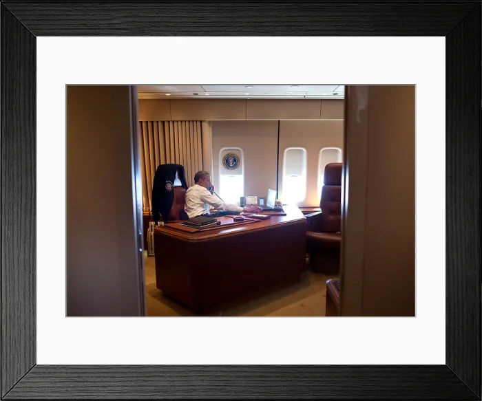 Framed Print : President Barack Obama holds a conference call with advisors from his office aboard Air Force One. July 24, 2012, during a flight to Portland, Oregon (BSLOC_2015_13_137)