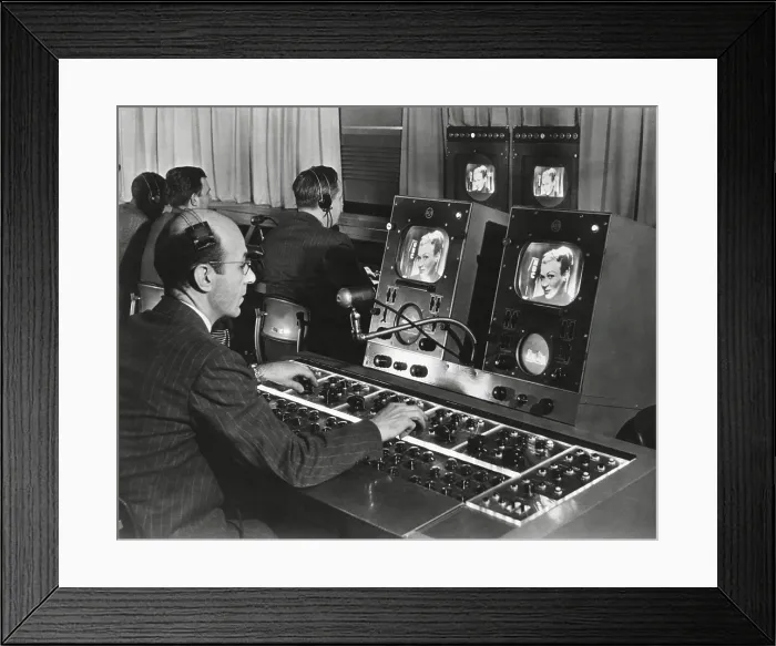 Framed Print : Television studio engineer gets several views of the image and use the complicated set of dials to control the tone and quality of the picture. Ca. 1950. New York City Framed Print : Television studio engineer gets several views of the image and use the complicated set of dials to control the tone and quality of the picture. Ca. 1950. New York City