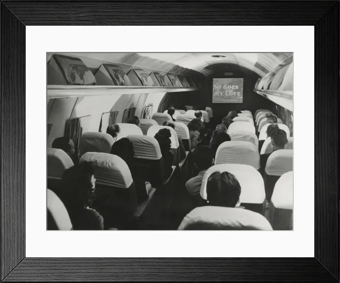 Framed Print : The film, So Goes my Love is projected on a Pan American Clipper, August 6, 1946. It was the first film shown during a cross-Atlantic flight. - (BSLOC_2014_17_128)