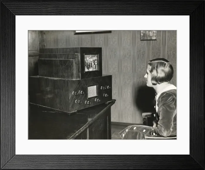 Framed Print : Woman watching a German television with a 14 x 18 centimeter screen. Transmission of live events was still not possible