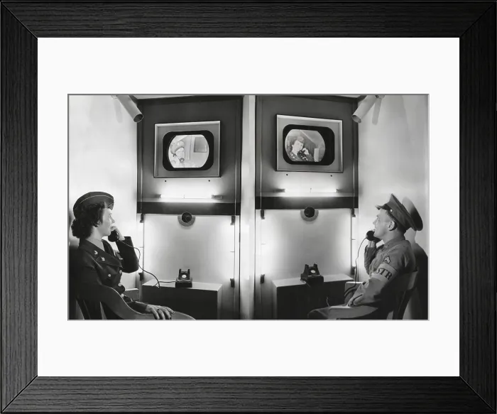 Framed Print : Video telephone conversation between an Army Corporal in Centralia, Pa. and a WAC in Seattle, Wash. Both can see the other in a video-telephone exhibit of the Signal Corps