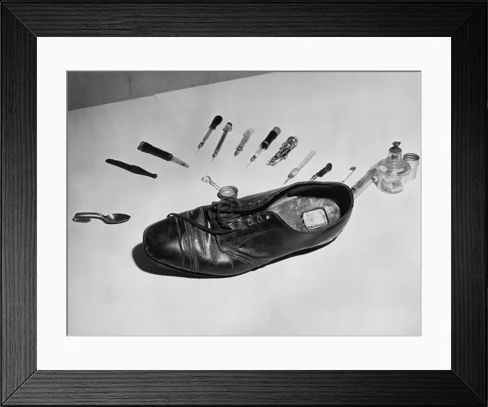 Framed Print : Law enforcement photo of a shoe with metal box in cut out section of heel used to smuggle drugs into a detention facility