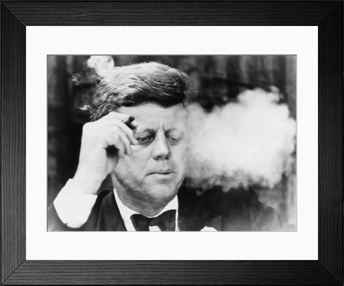 Framed Print : President John Kennedy, smoking a small cigar at a Democratic fundraiser in Boston's Commonwealth Armory. Oct. 19, 1963 Framed Print : President John Kennedy, smoking a small cigar at a Democratic fundraiser in Boston's Commonwealth Armory. Oct. 19, 1963