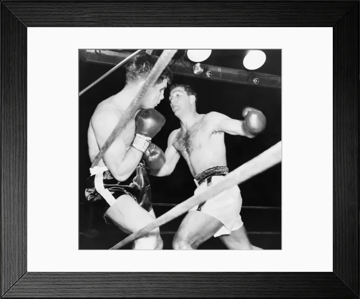 Framed Print : Heavyweight champion Rocky Marciano (right) backs Roland LaStarza against the ropes. Sept. 24, 1953