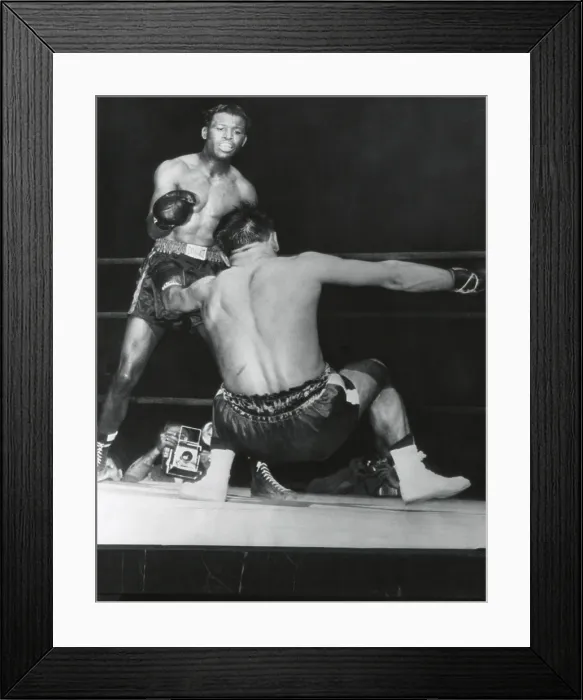 Framed Print : Robert Villemain, goes down from a punch by Sugar Ray Robinson in the 12th round. French middleweight got up and completed the fight. Robinson won by unanimous decision