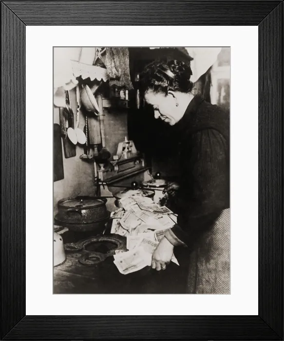 Framed Print : German women burning money to fuel her stove during the post World War I hyper-inflation in 1923. At the time, an American dollar was worth 800 million German marks Framed Print : German women burning money to fuel her stove during the post World War I hyper-inflation in 1923. At the time, an American dollar was worth 800 million German marks